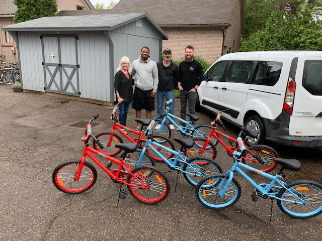 Donated bikes with board and community members