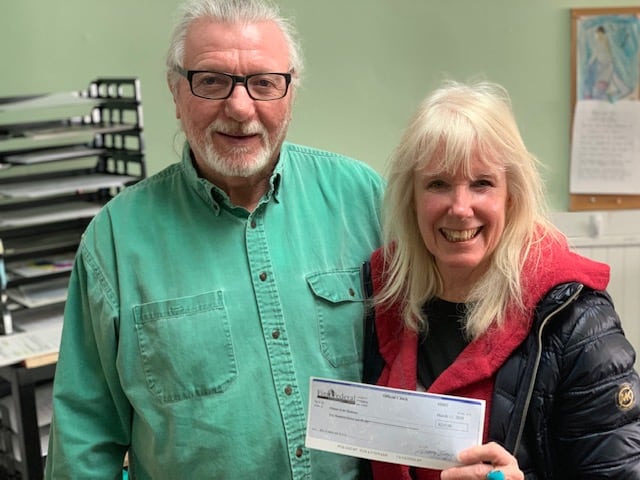Calvin White and Holly Waldenmyer with check